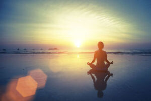 woman-meditating-on-beach